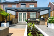 Deponti Giallo Aluminium Pergola Veranda Grey - Front View with Sofa Set in Front of House
