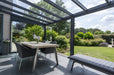 Deponti Pigato Aluminium Pergola Veranda Grey - Inside View with Dining Table in Front of the House