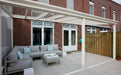Deponti Pigato Aluminium Pergola Veranda White - Front View with Sofa in Front of the House